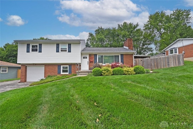 141 Arlington Ave, Franklin, OH 45005 - tri-level home featuring brick siding, driveway, a chimney, and an attached garage