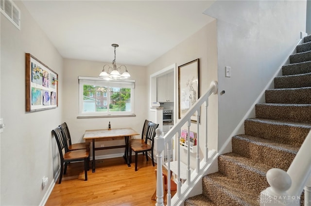448 Triangle Ave, Oakwood, OH 45419 - staircase with wood finished floors and a chandelier