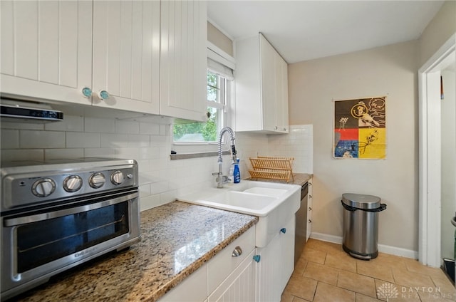 448 Triangle Ave, Oakwood, OH 45419 - kitchen featuring white cabinets, range hood, backsplash, light tile patterned flooring, and light stone counters