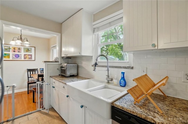 448 Triangle Ave, Oakwood, OH 45419 - kitchen featuring decorative backsplash, white cabinets, and pendant lighting
