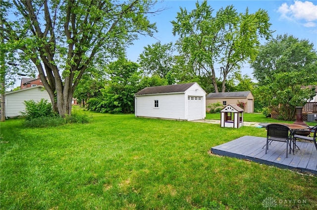 448 Triangle Ave, Oakwood, OH 45419 - view of green lawn with an outdoor structure, a garage, and a deck