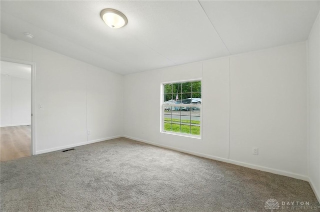 665 Diamond Loop, Middletown, OH 45044 - empty room featuring carpet, baseboards, lofted ceiling, and a smoke detector