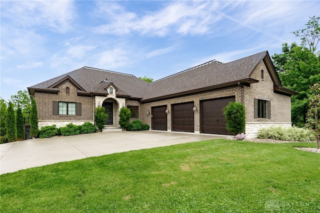 6481 Stagecoach Way, Liberty Twp, OH 45011 - french country inspired facade with brick siding, driveway, a garage, stone siding, and a front lawn