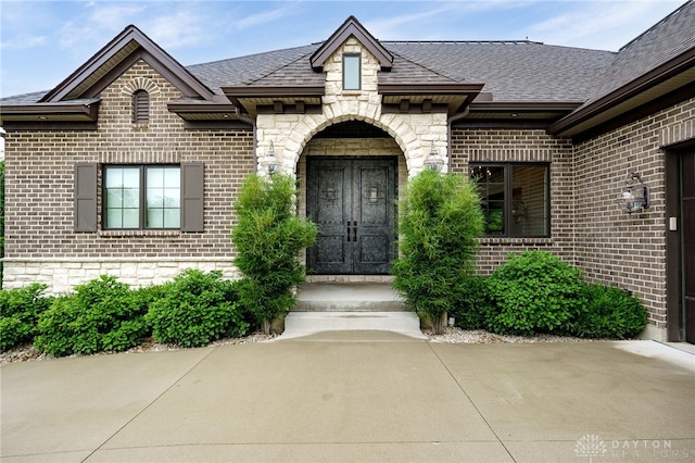 6481 Stagecoach Way, Liberty Twp, OH 45011 - view of exterior entry with brick siding, roof with shingles, and stone siding