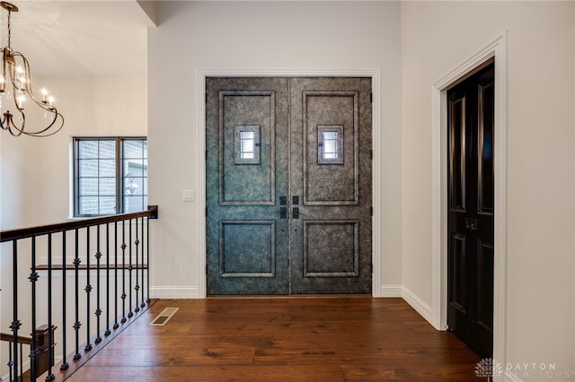 6481 Stagecoach Way, Liberty Twp, OH 45011 - entryway featuring a chandelier, dark wood-style flooring, and baseboards