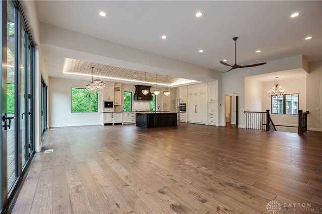 6481 Stagecoach Way, Liberty Twp, OH 45011 - unfurnished living room with a chandelier, dark wood-style flooring, baseboards, and recessed lighting