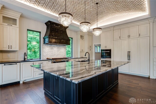6481 Stagecoach Way, Liberty Twp, OH 45011 - kitchen featuring a sink, wall oven, a chandelier, brick ceiling, and custom range hood