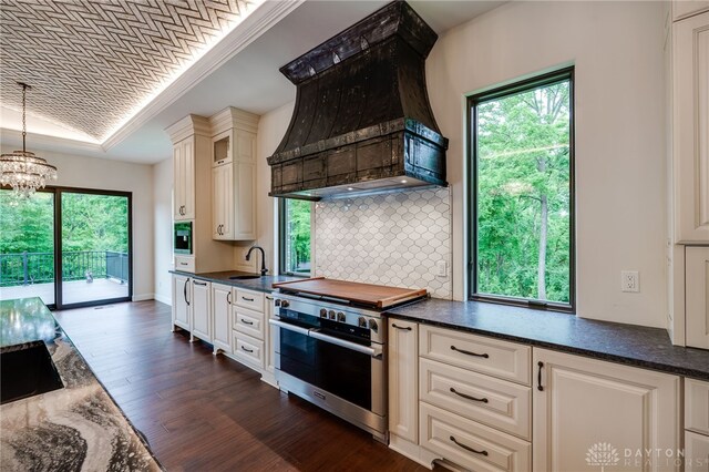 6481 Stagecoach Way, Liberty Twp, OH 45011 - kitchen featuring range with two ovens, custom range hood, dark wood-type flooring, a chandelier, and tasteful backsplash