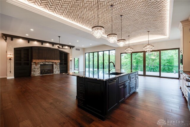 6481 Stagecoach Way, Liberty Twp, OH 45011 - kitchen with a sink, a fireplace, a chandelier, recessed lighting, and dark cabinets