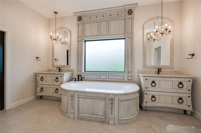6481 Stagecoach Way, Liberty Twp, OH 45011 - bathroom with a chandelier, a bath, two vanities, and baseboards