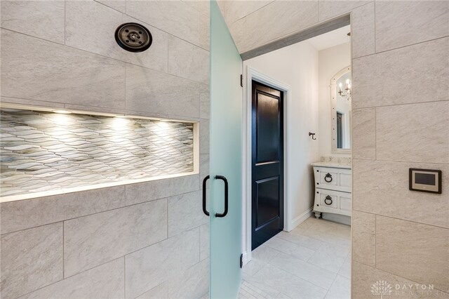 6481 Stagecoach Way, Liberty Twp, OH 45011 - bathroom featuring a stall shower, vanity, a chandelier, tile walls, and tile patterned flooring
