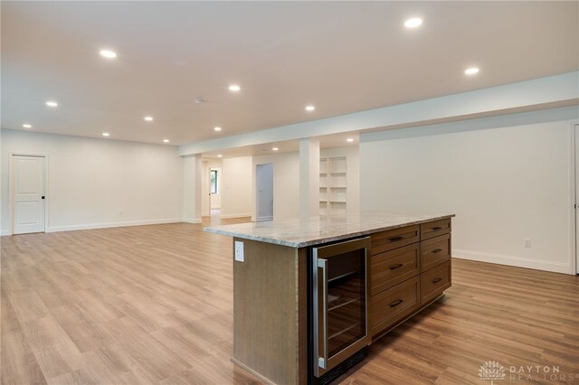 6481 Stagecoach Way, Liberty Twp, OH 45011 - kitchen with beverage cooler, baseboards, a kitchen island, light wood-style flooring, and recessed lighting