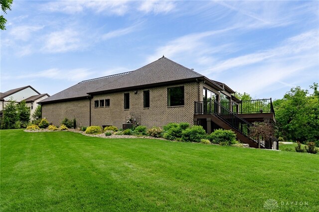 6481 Stagecoach Way, Liberty Twp, OH 45011 - view of side of property featuring stairway, a lawn, a wooden deck, and brick siding