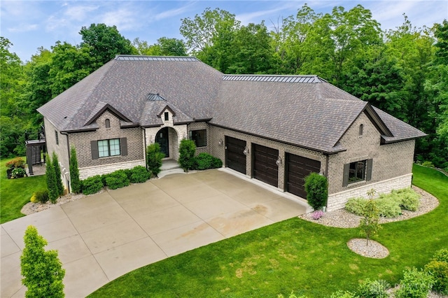 6481 Stagecoach Way, Liberty Twp, OH 45011 - french provincial home featuring stone siding, an attached garage, brick siding, concrete driveway, and a front lawn