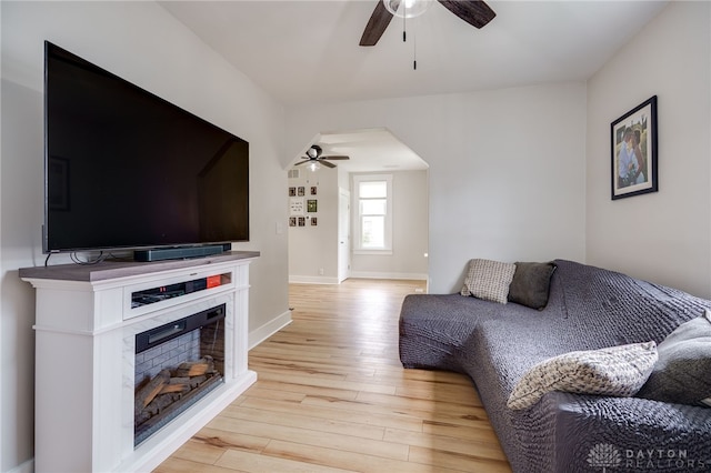 602 W N St, Arcanum, OH 45304 - living area with ceiling fan, light wood-style flooring, a glass covered fireplace, and baseboards