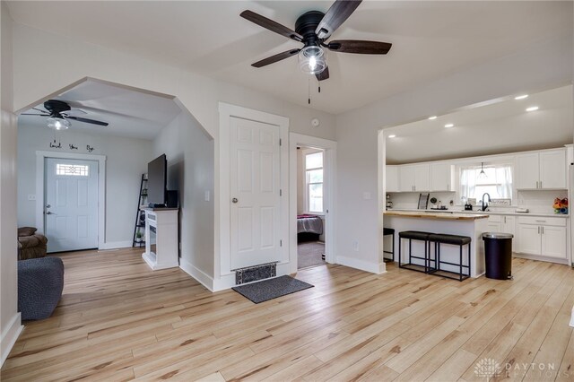 602 W N St, Arcanum, OH 45304 - living room with ceiling fan, light wood-style flooring, and baseboards