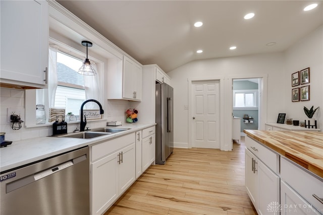 602 W N St, Arcanum, OH 45304 - kitchen featuring appliances with stainless steel finishes, a sink, recessed lighting, light wood-style flooring, and white cabinetry