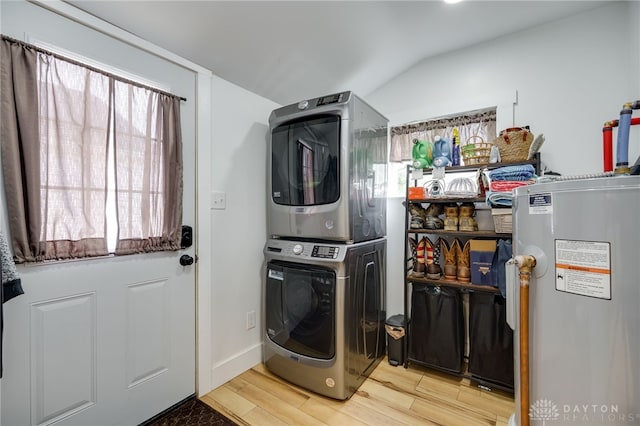 602 W N St, Arcanum, OH 45304 - laundry area featuring stacked washer / dryer, electric water heater, wood finished floors, and baseboards