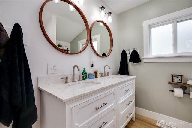 602 W N St, Arcanum, OH 45304 - bathroom with double vanity, wood finished floors, and baseboards