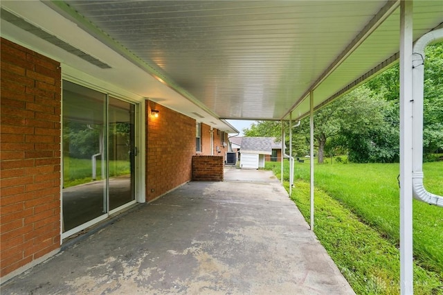 2424 Pinegrove Dr, Dayton, OH 45449 - view of patio with an outbuilding, an attached carport, and central AC