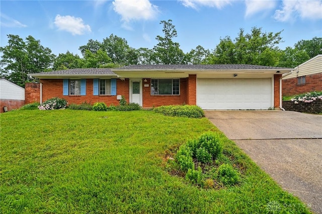 2424 Pinegrove Dr, Dayton, OH 45449 - ranch-style house with an attached garage, driveway, brick siding, and a front yard