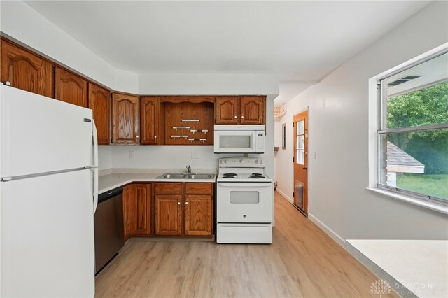 2424 Pinegrove Dr, Dayton, OH 45449 - kitchen with white appliances, light wood-type flooring, light countertops, and brown cabinetry