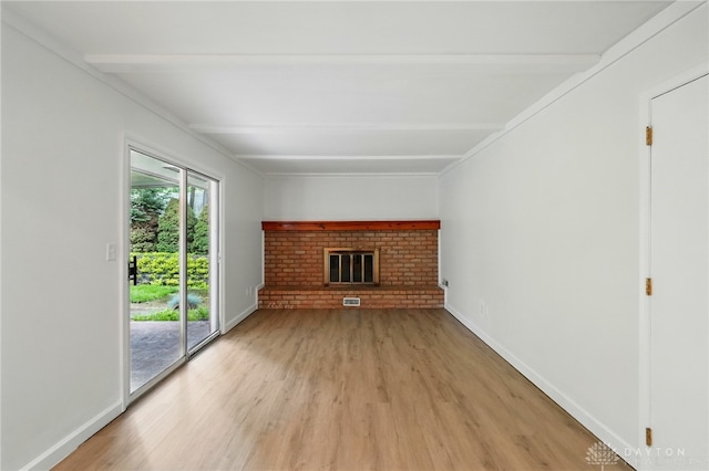 2424 Pinegrove Dr, Dayton, OH 45449 - unfurnished living room with light wood-style floors, a fireplace, beamed ceiling, and baseboards