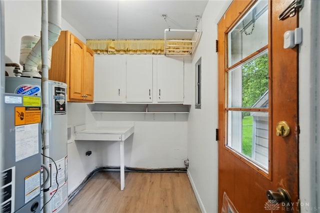 2424 Pinegrove Dr, Dayton, OH 45449 - laundry room featuring light wood finished floors, water heater, baseboards, and cabinet space