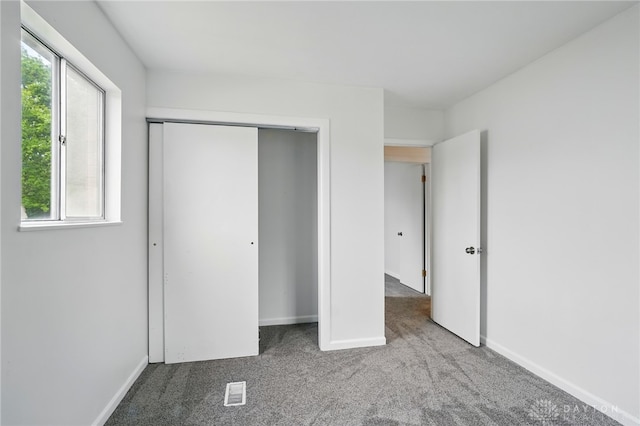 2424 Pinegrove Dr, Dayton, OH 45449 - unfurnished bedroom with carpet flooring, baseboards, and a closet