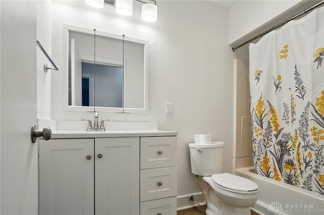 2424 Pinegrove Dr, Dayton, OH 45449 - bathroom featuring vanity, toilet, shower / bath combination with curtain, and baseboards