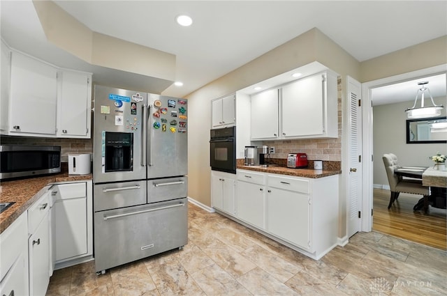 5571 Hugh Dr, Dayton, OH 45459 - kitchen with appliances with stainless steel finishes, dark countertops, backsplash, white cabinets, and recessed lighting