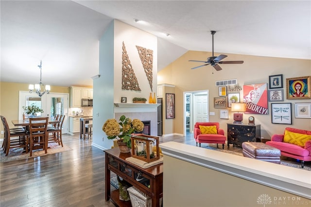 2182 Sharon View Ct, Lebanon, OH 45036 - living area featuring ceiling fan, a chandelier, a tiled fireplace, high vaulted ceiling, and dark wood-type flooring