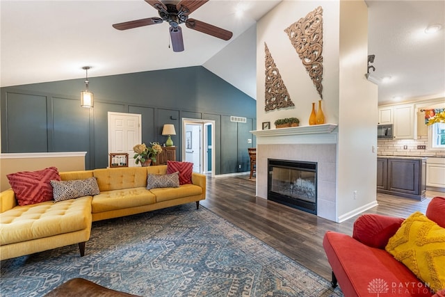 2182 Sharon View Ct, Lebanon, OH 45036 - living room with ceiling fan, vaulted ceiling, wood finished floors, and a tile fireplace