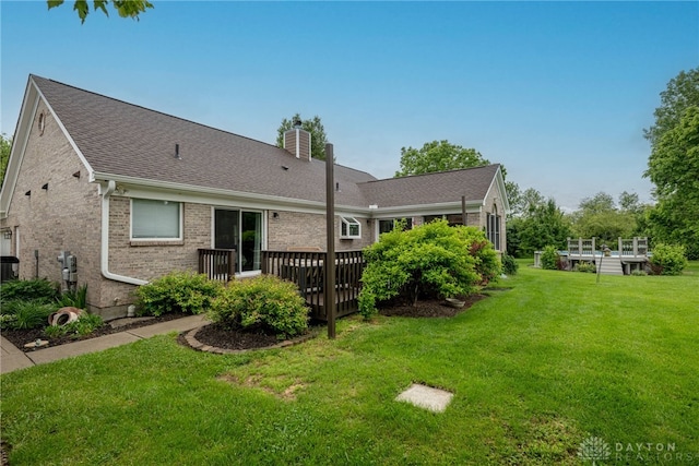 2182 Sharon View Ct, Lebanon, OH 45036 - back of house with a deck, a chimney, a lawn, and brick siding