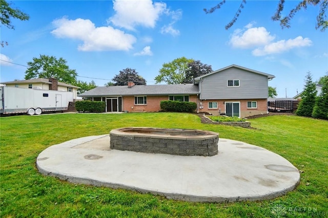 2369 Brown Bark Dr, Beavercreek, OH 45431 - rear view of property featuring an outdoor fire pit, a lawn, and a patio area