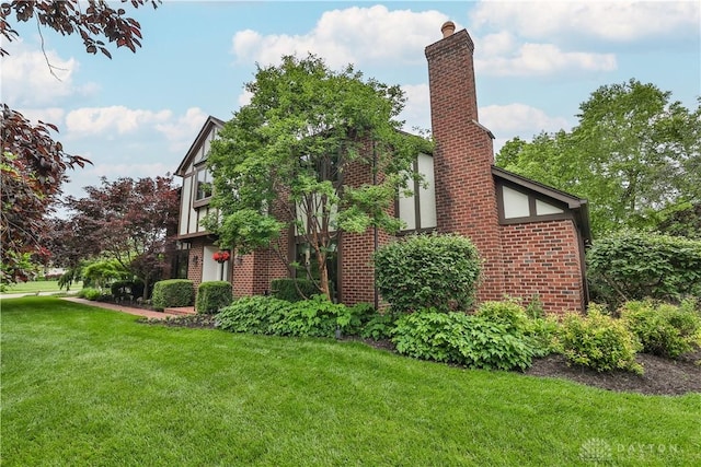 2031 Vienna Pkwy, Dayton, OH 45459 - view of side of home featuring a lawn, brick siding, and a chimney