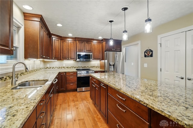 10550 Willow Brook Rd, Dayton, OH 45458 - kitchen with stainless steel appliances, a sink, decorative backsplash, light wood-style flooring, and light stone countertops