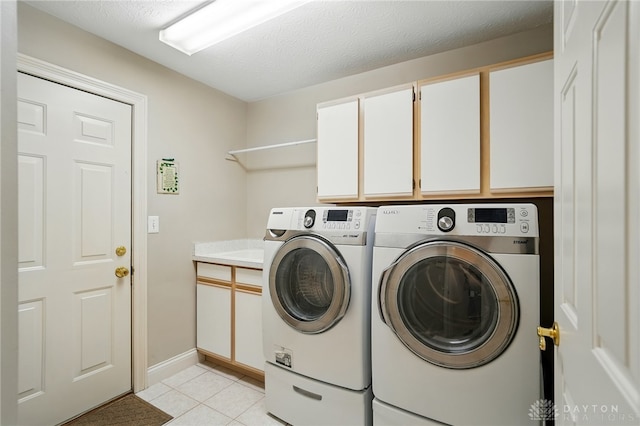 10550 Willow Brook Rd, Dayton, OH 45458 - laundry room with washing machine and clothes dryer, cabinet space, and light tile patterned flooring