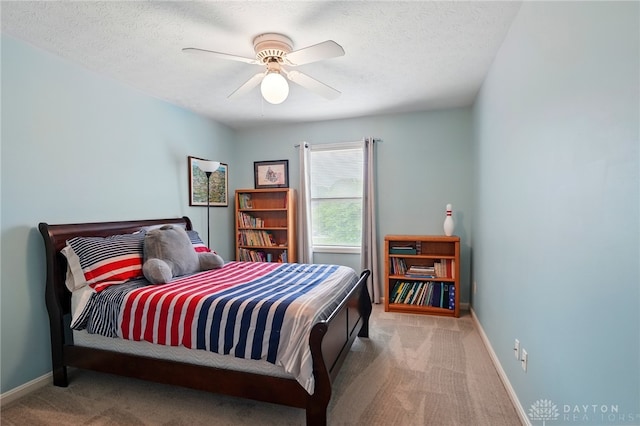 10550 Willow Brook Rd, Dayton, OH 45458 - carpeted bedroom with baseboards, a textured ceiling, and a ceiling fan