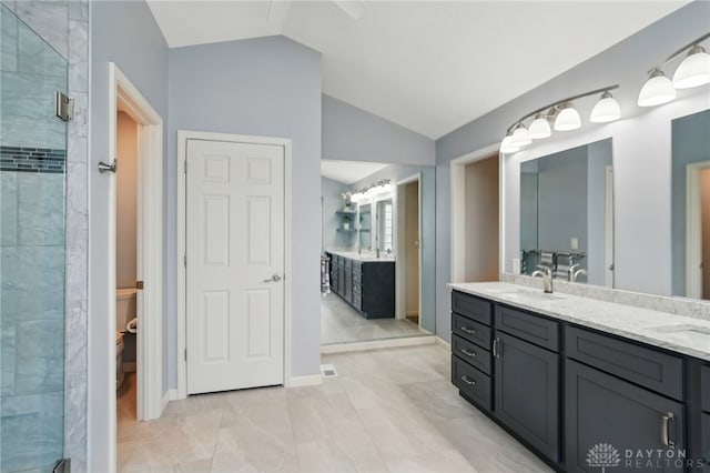 10550 Willow Brook Rd, Dayton, OH 45458 - bathroom featuring vaulted ceiling, a stall shower, double vanity, toilet, and baseboards