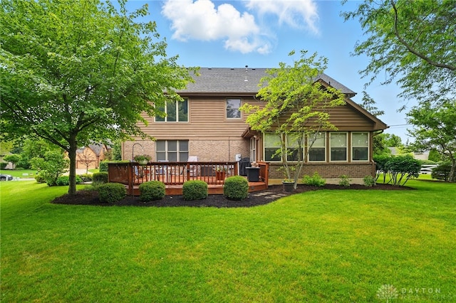 10550 Willow Brook Rd, Dayton, OH 45458 - rear view of property featuring brick siding, a wooden deck, and a yard