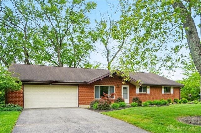 600 Deauville Dr, Washington Twp, OH 45429 - single story home with asphalt driveway, a garage, a front lawn, and brick siding