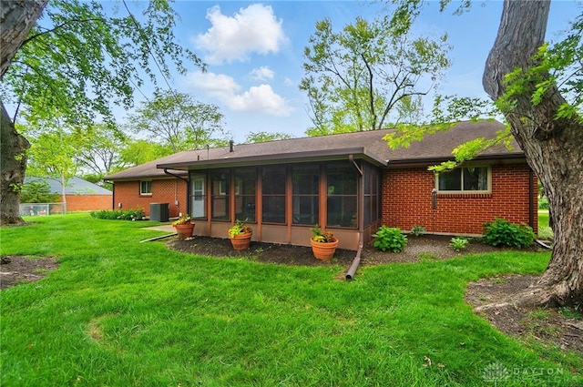 600 Deauville Dr, Washington Twp, OH 45429 - rear view of house with a sunroom, central air condition unit, and brick siding