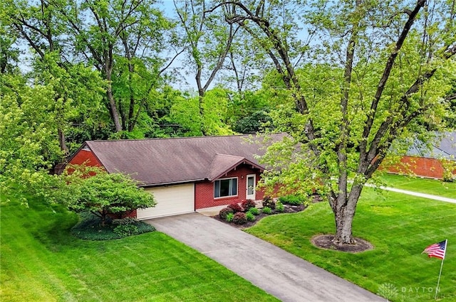 600 Deauville Dr, Washington Twp, OH 45429 - view of front of home featuring driveway, a garage, a front yard, and brick siding