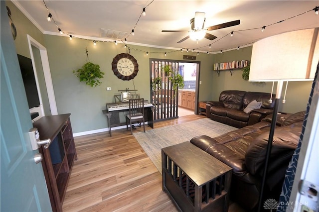 1265 Jeanette Dr, Dayton, OH 45432 - living area with rail lighting, light wood-style floors, a ceiling fan, baseboards, and crown molding