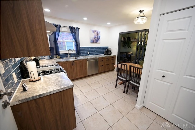 1265 Jeanette Dr, Dayton, OH 45432 - kitchen featuring stainless steel dishwasher, a sink, tasteful backsplash, light tile patterned floors, and light stone counters