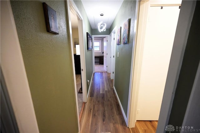 1265 Jeanette Dr, Dayton, OH 45432 - hall featuring wood finished floors, a textured wall, and baseboards