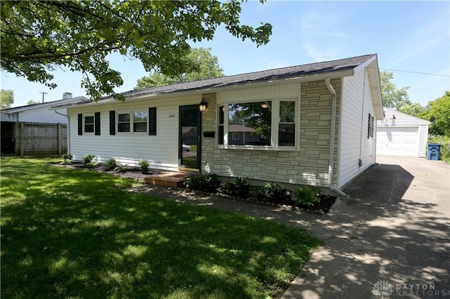 1265 Jeanette Dr, Dayton, OH 45432 - view of front facade with stone siding, an outbuilding, a garage, and driveway