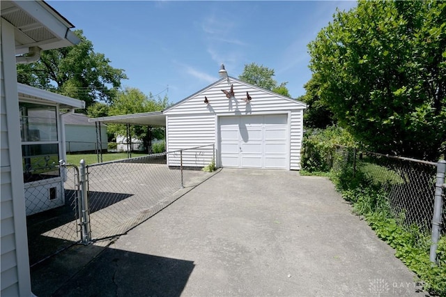 1265 Jeanette Dr, Dayton, OH 45432 - garage featuring driveway, a detached garage, and a gate