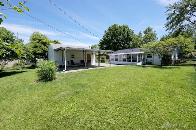1265 Jeanette Dr, Dayton, OH 45432 - back of property with a sunroom and a lawn